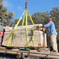 Ancient Sarcophagus being lifted from a truck by a crane